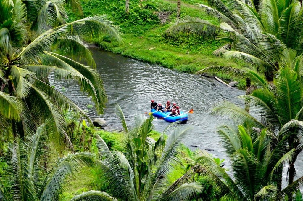 Group of people rafting on the Ayung River. During your one week in Ubud, go on an adventure and raft the rapids of the river.
