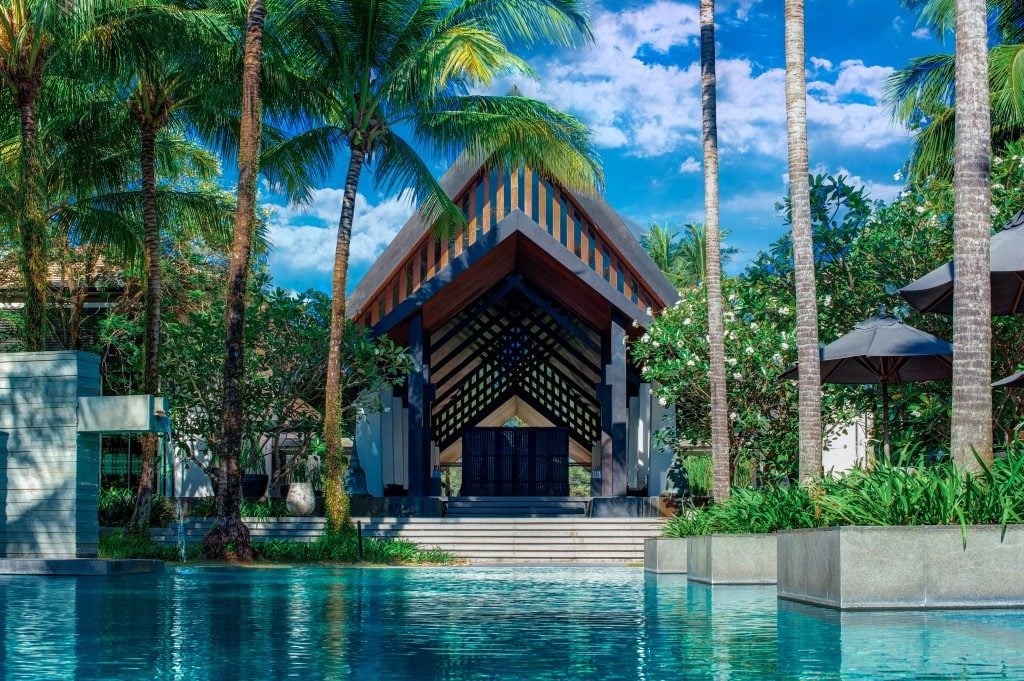 Chic and luxurious pool in front of a hotel entrance