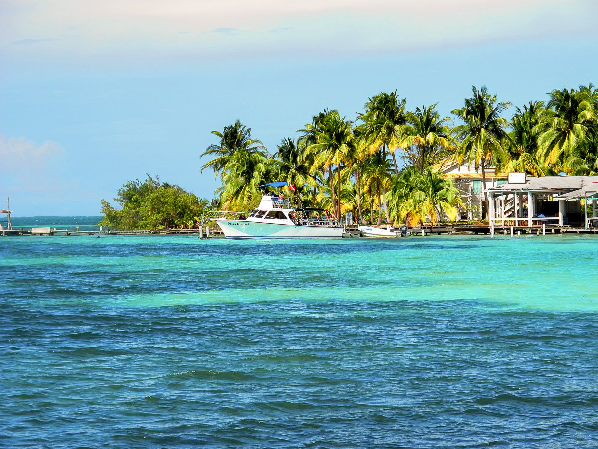 Stunning blue and green ocean waters surrounding a small caye in Belize.
