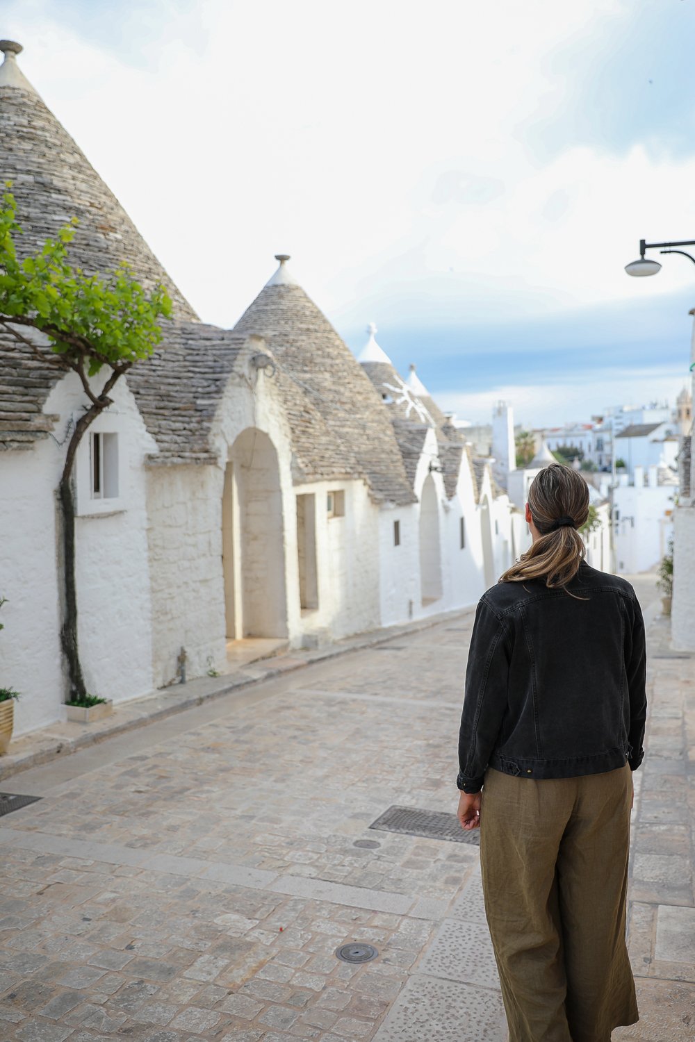 Maddy strolling along cobblestoned paths of Alberobello