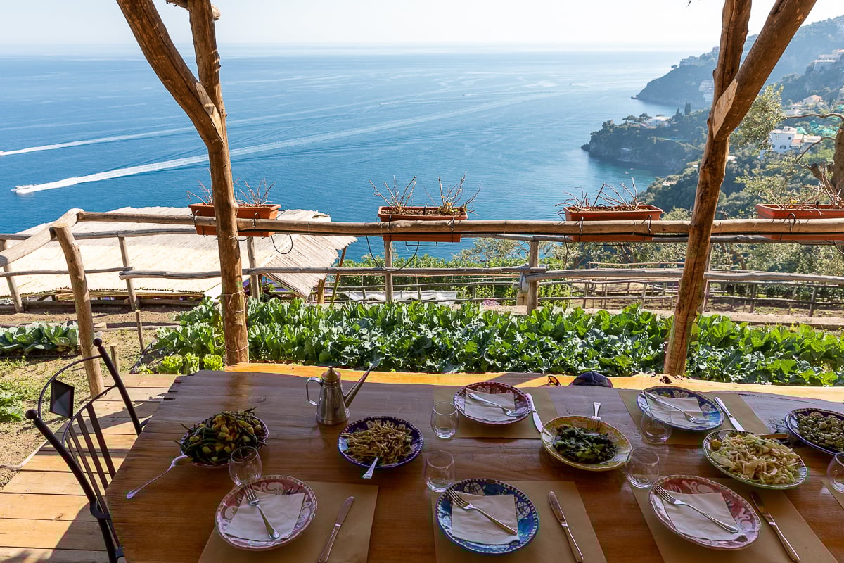 Different dishes served on a table overlooking magnificent ocean views