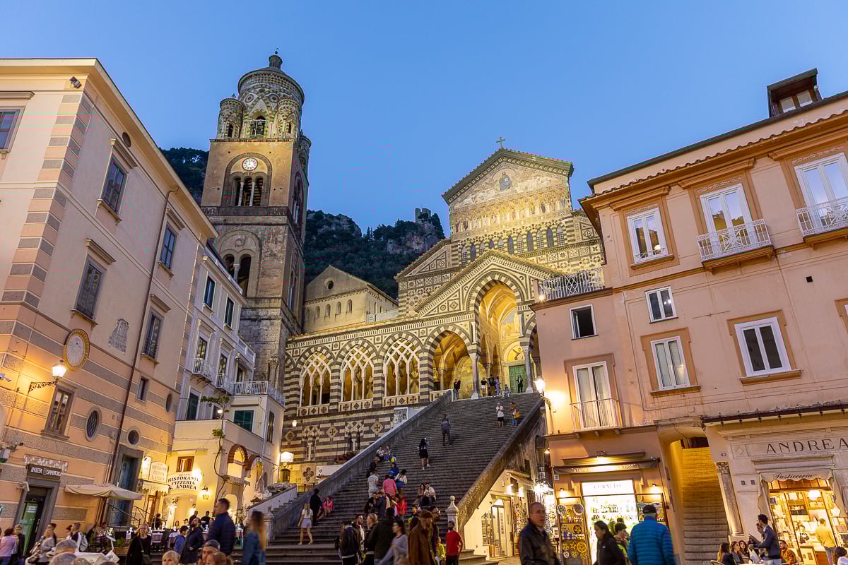 Busy crowd and churchgoers roaming around Piazza Duomo in Amalfi Town at dusk