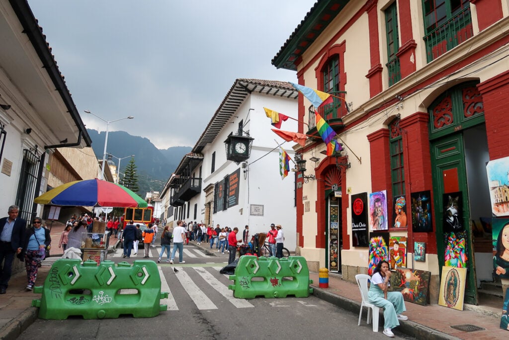 Colorful street in La Candelaria decorated with rainbow flags and paintings for sale