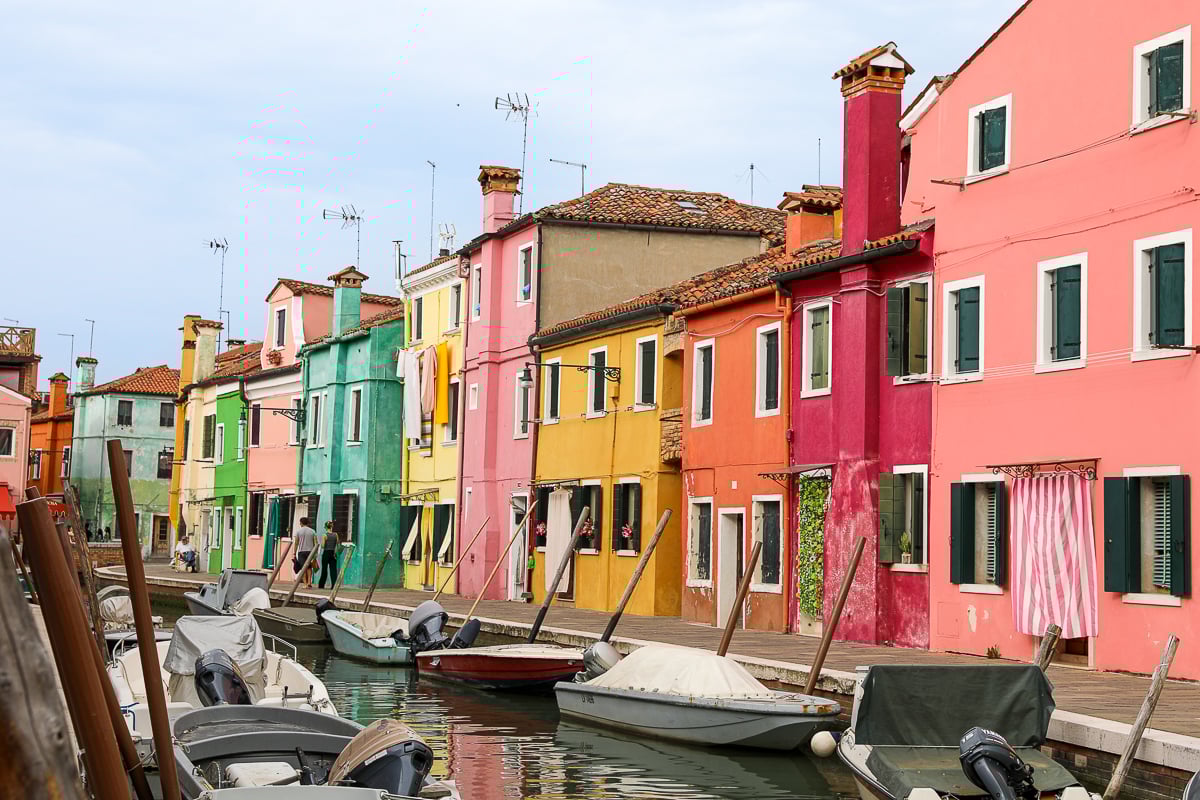 A colorful street on the island of Burano; a boat tour to Burano and Murano is a must add to your 2 days in Venice itinerary!