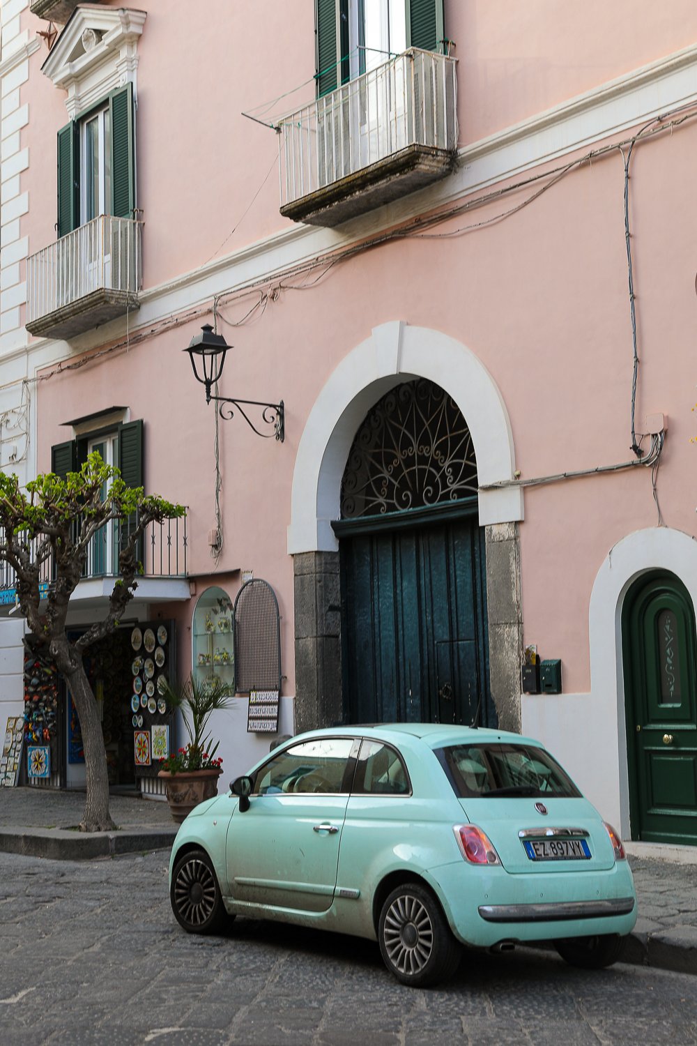 Small car parked outside a souvenir shop in Ischia, Italy