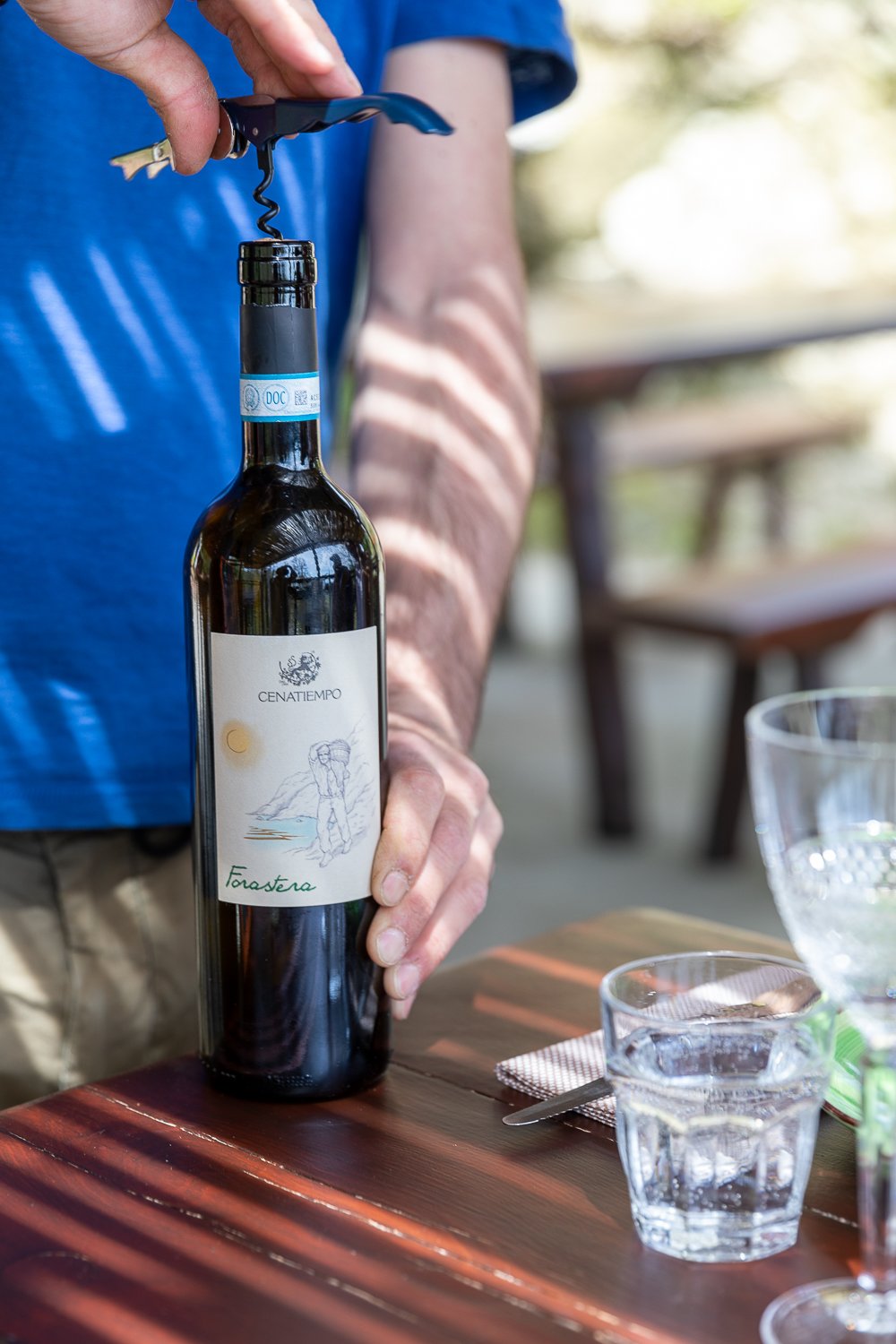 Opening a bottle of Cenatiempo wine