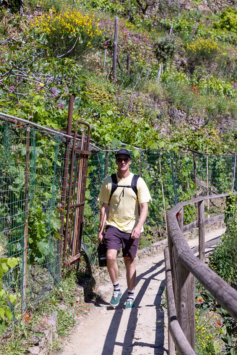 Cacey walking along a nature hiking trail during a day trip to Cinque Terre from Florence