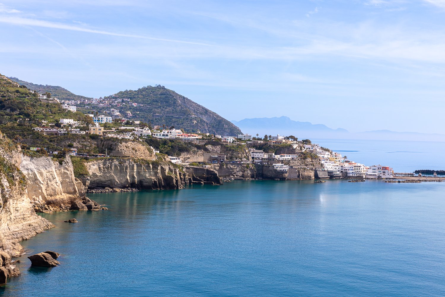 Blue ocean waters by the coastline of Ischia, Italy