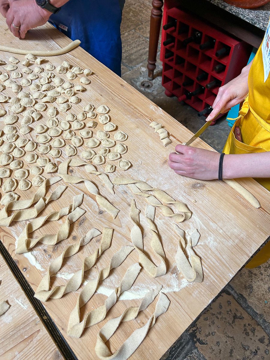 Making orecchiette pasta in Italy. In this guide to the best things to do in Alberobello, I highly recommend taking a cooking class and learning about Puglia's culture.