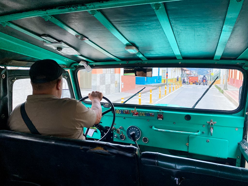 A Willy driver maneuvering the vehicle's wheel as seen from the passenger seats.