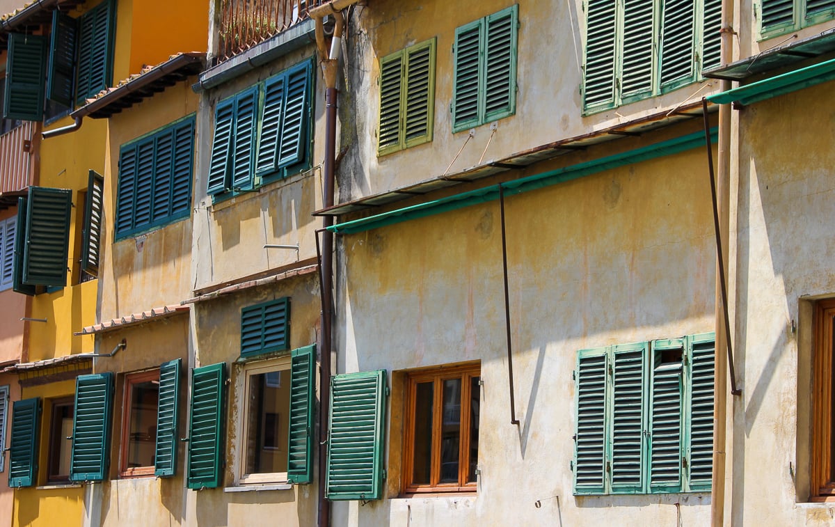 Old windows and buildings in Florence. Exploring the city on foot is a must-include in your Florence itinerary.