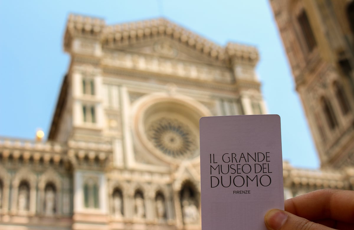 Holding up a ticket to Il Grande Museo del Duomo. Don't forget this ticket from your Duomo tour so you can explore other historical landmarks during your 3 days in Florence.