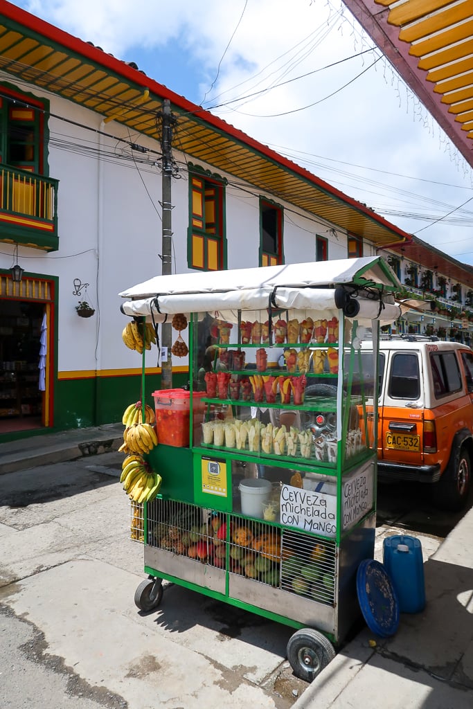 A food truck in Salento that sells various street food and fresh fruits by a street in Salento