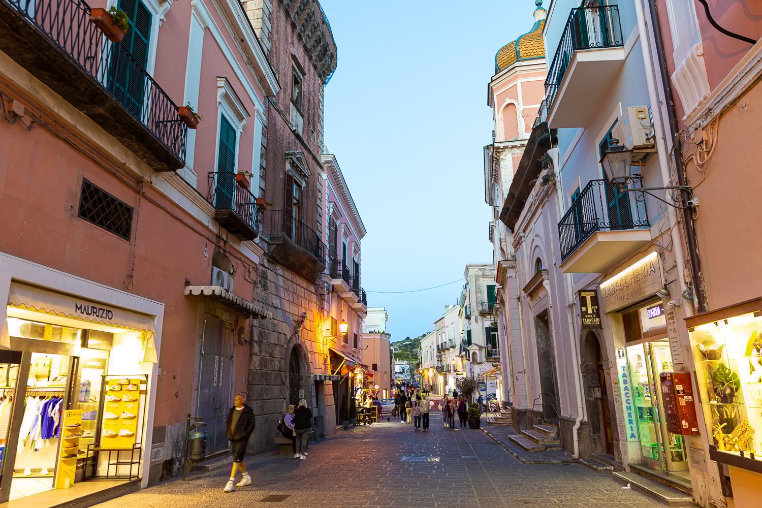 People strolling along the main street in Forio, Ischia at dusk