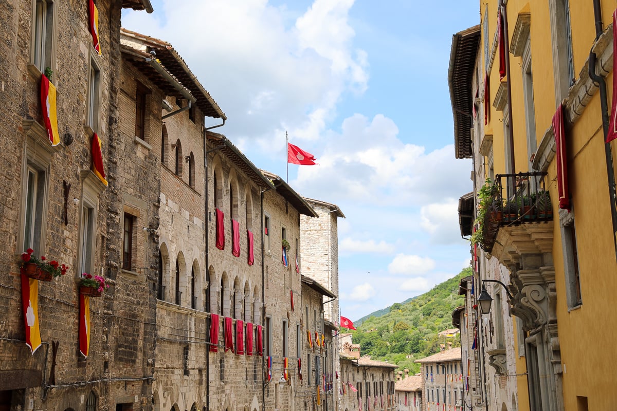 An old street in the town of Gubbio, Umbria decorated with lots of medieval-style flags