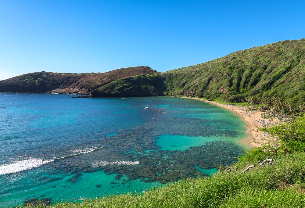 Clear waters and surrounding greeneries at Hanauma Bay Nature Reserve. Snorkeling here is a must-include activity in your Oahu itinerary.