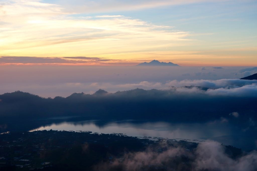 View above the Mount Batur as it was covered with fog at sunrise. The Mount Batur sunrise trek is one of the best things to do during your one week in Ubud.