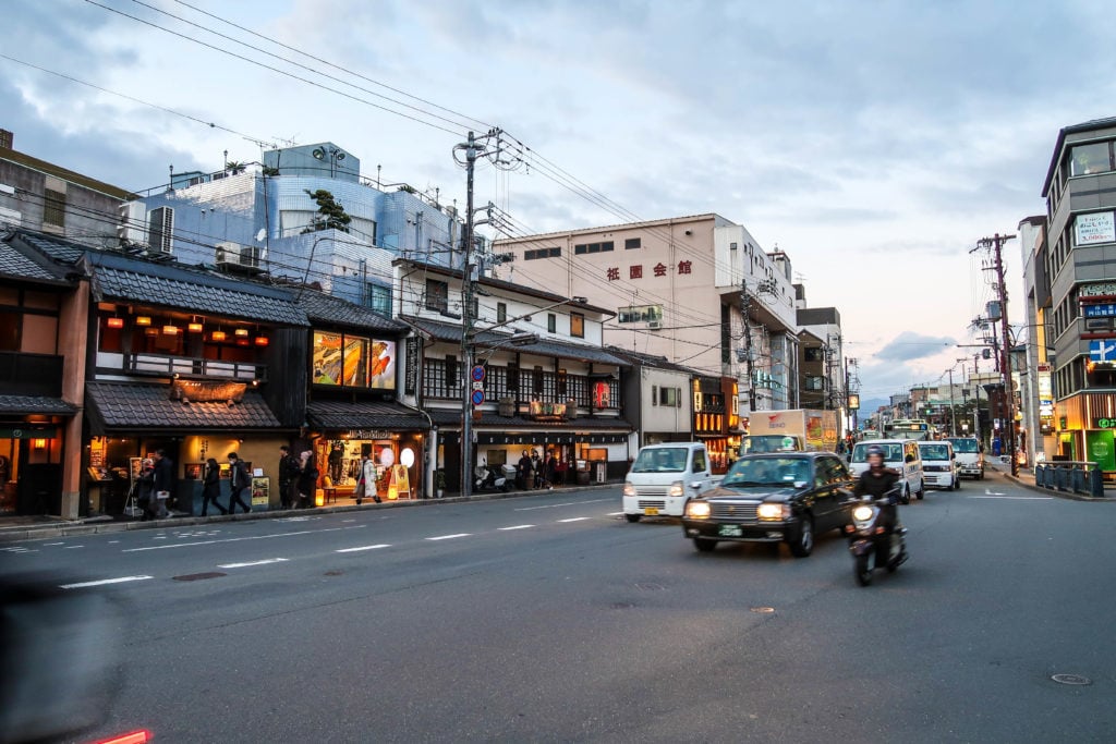 Vehicles on a road in Kyoto, Japan at dusk