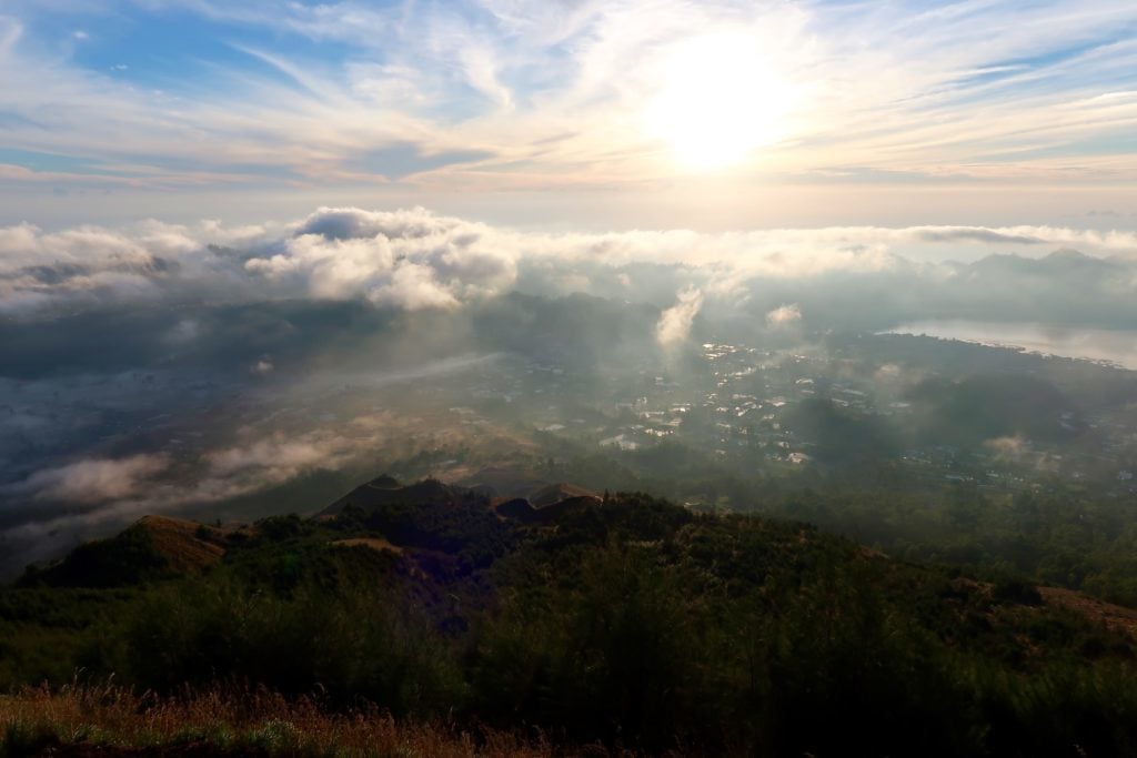 Sun slowly lighting up the villages at the foot of Mount Batur