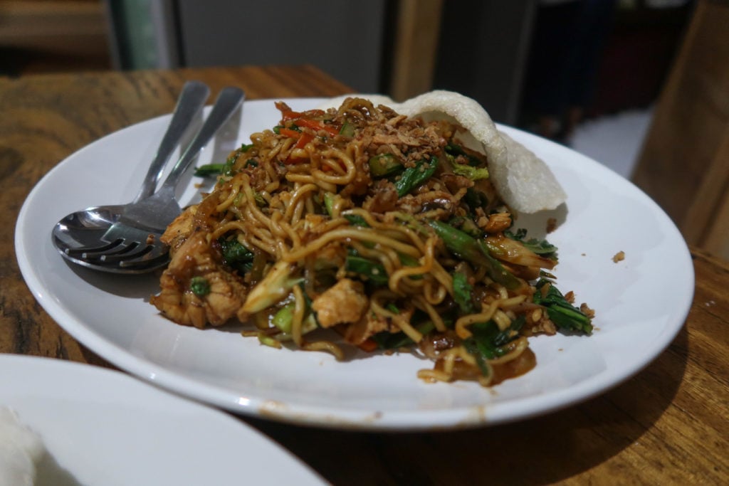 Noodles on white place with meat and crackers