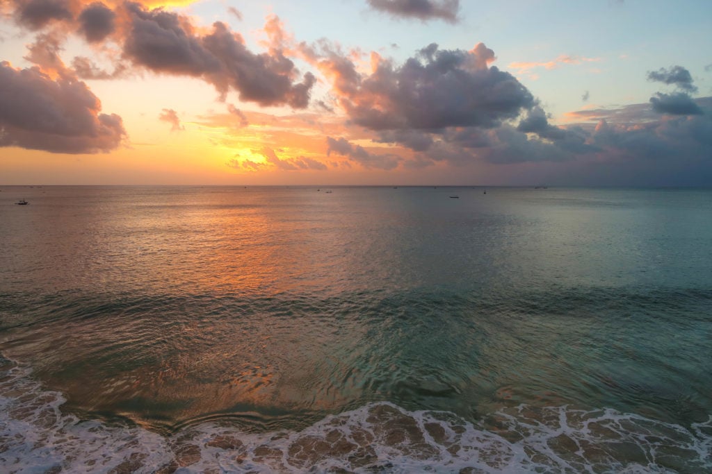Waves at the beach during sunset. Your three weeks in Bali won't be complete without a visit to its wonderful beaches.