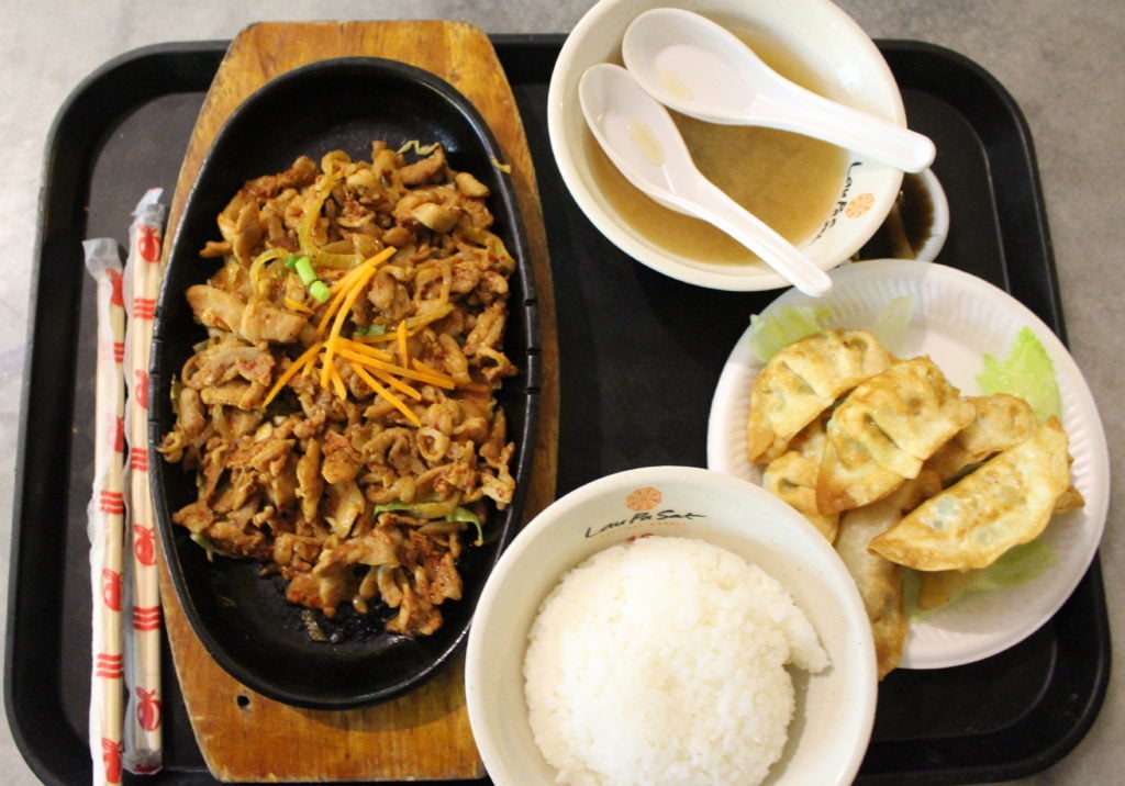 Asian dish with rice and wonton soup. On your 24-hour layover in Singapore, experience authentic Asian food at local food stalls.