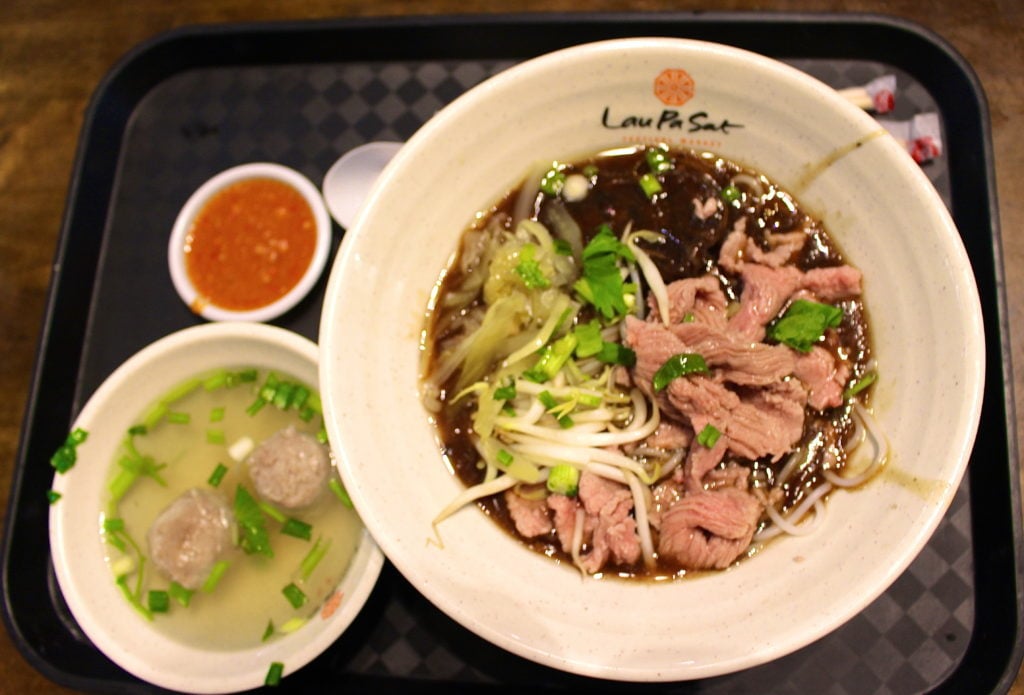 Delicious Hainanese chicken rice dish served on bowls - a must-try dish during your 24-hour layover in Singapore