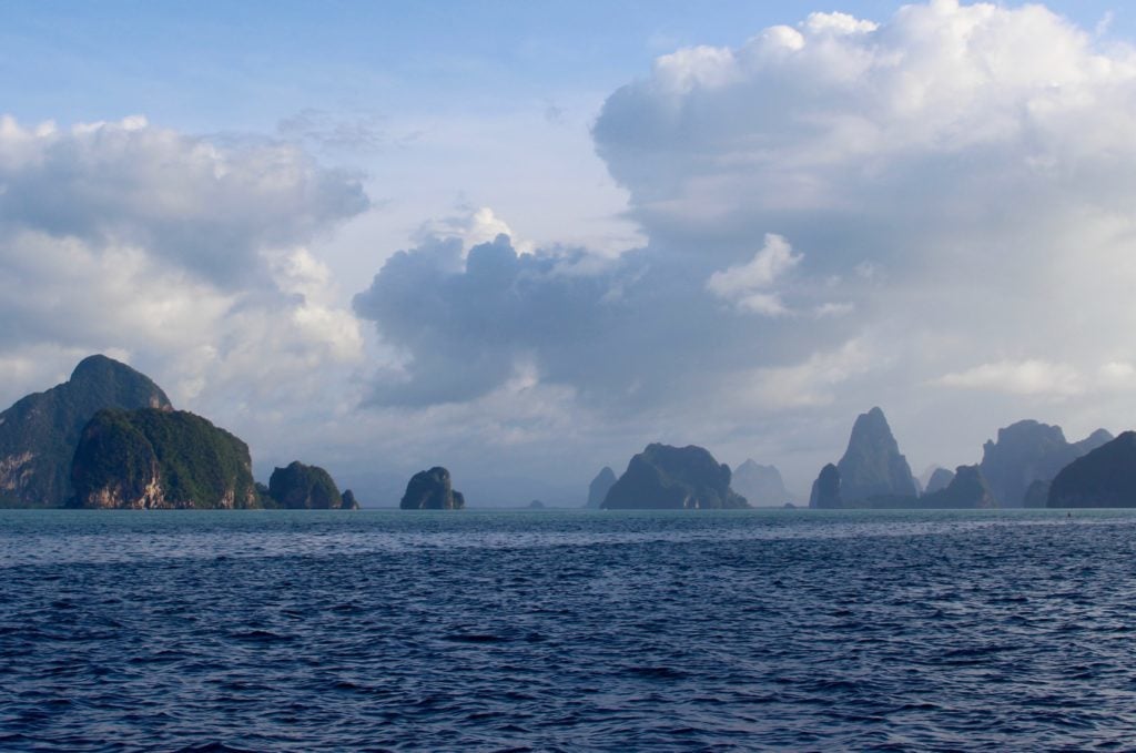 Rock formations as seen from afar under cloudy skies