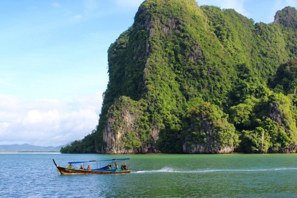 Boat cruising around while island hopping in Thailand