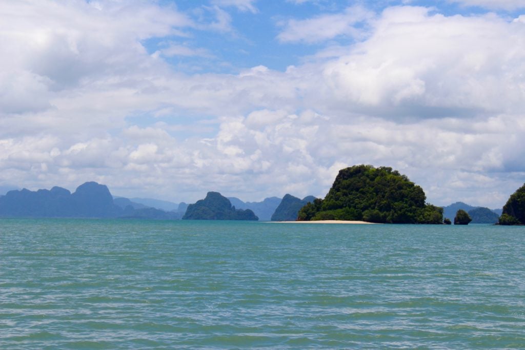 Nearby lush island as viewed from the middle of the sea