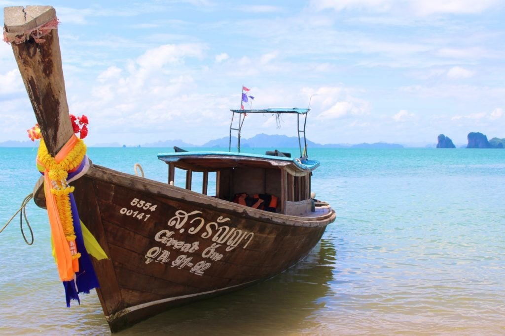 A decorated boat docked by the beach