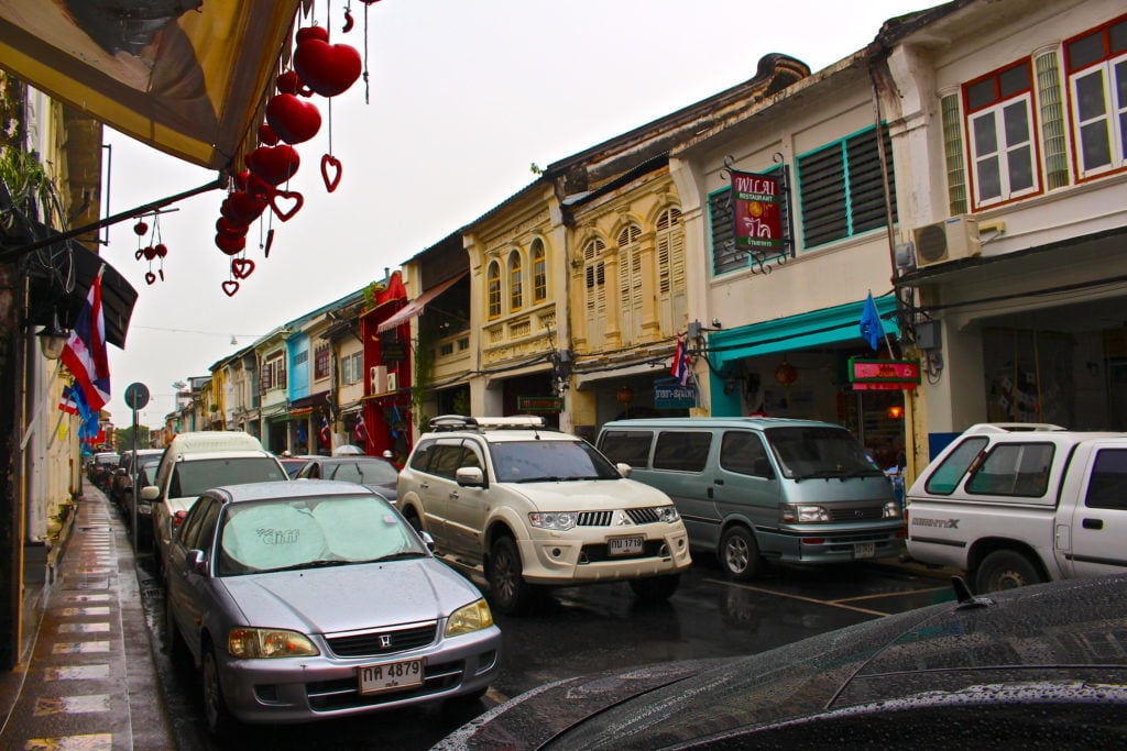 Vehicles stuck in traffic on a road in Phuket Old Town