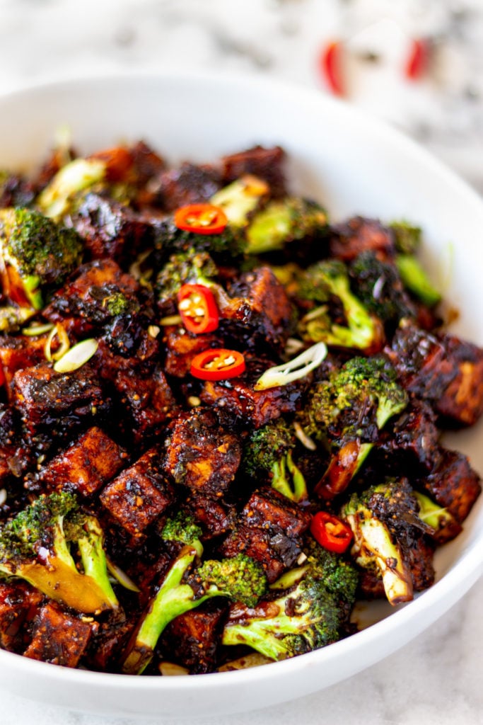 Imagine this: Crispy tofu and vibrant, crunchy broccoli, tossed through a spicy, gingery, black peppery, sweet, and salty sauce. Served with fluffy rice. And topped with fresh green onions and red chilis. Oh my goodness, yes. I'm talking about my recipe for Black Pepper Tofu and Broccoli.