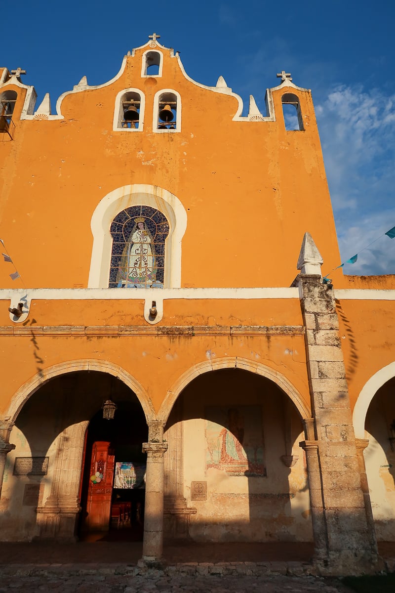 Yellow exterior and facade of Convento de San Antonio de Padua. Visiting the convent is one of the things to do in Izamal.