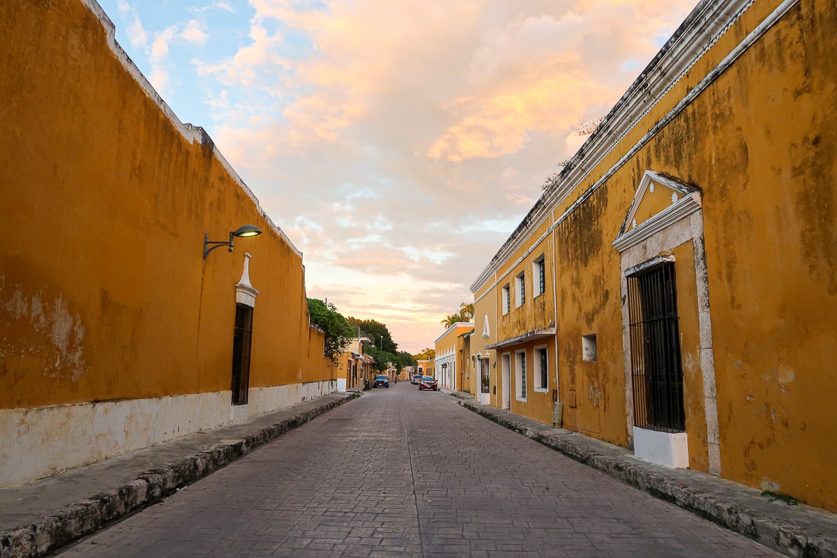 Quiet street of Izamal lined with yellow buildings