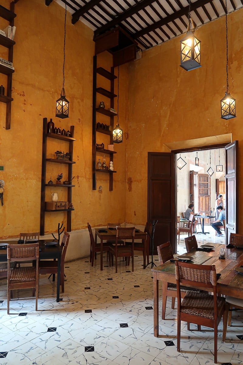 Dining tables and chairs at a Yucatecan restaurant. Eating traditional Yucatecan food is one of the things to do in Izamal, Yucatan Peninsula.