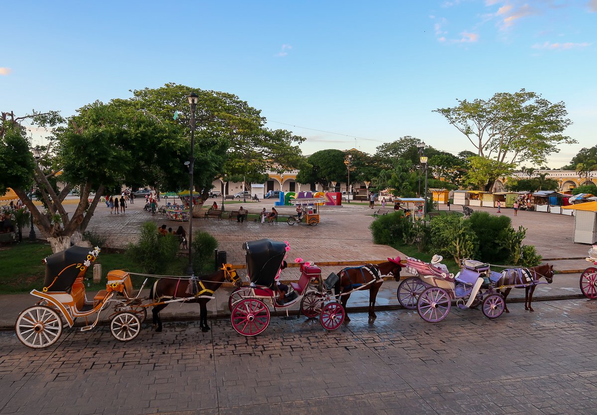 Horse carriages in Izamal. Riding a horse-drawn carriage to explore the area is one of the amazing things to do in Izamal, Mexico.