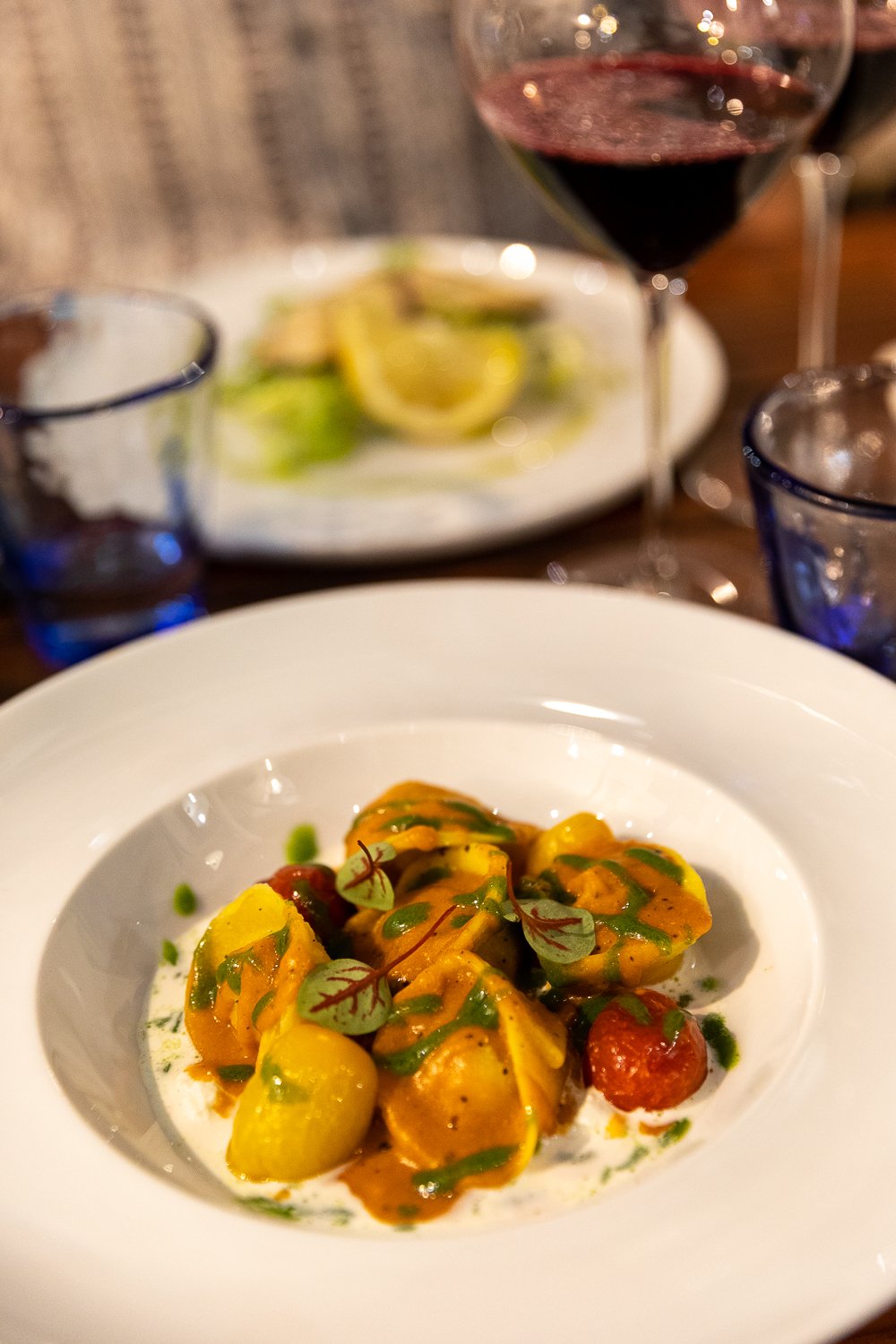 Serving of shrimp tortellini in burrata cream sauce with tomatoes at Kantharos, one of the best restaurants in Ischia, Italy