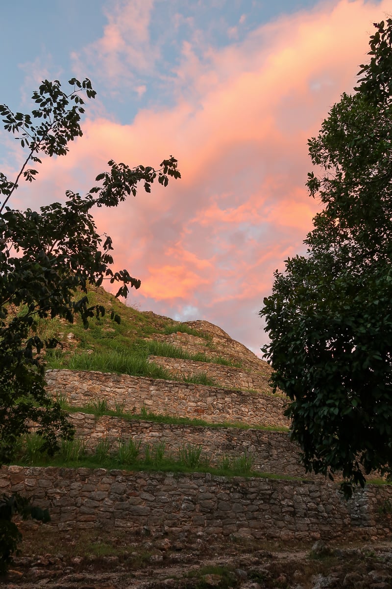 Beautiful view of orange-pink hues of clouds above the Kinich Kakmó Pyramid. Visiting this Mayan pyramid is one of the fun things to do in Izamal.