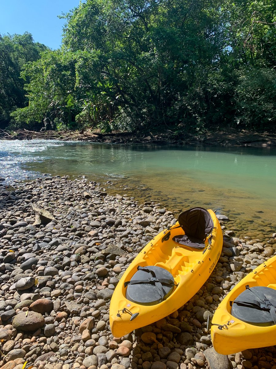 Two yellow kayaks by the river. This Costa Rica guide recommends kayaking in La Fortuna for a richer adventure.