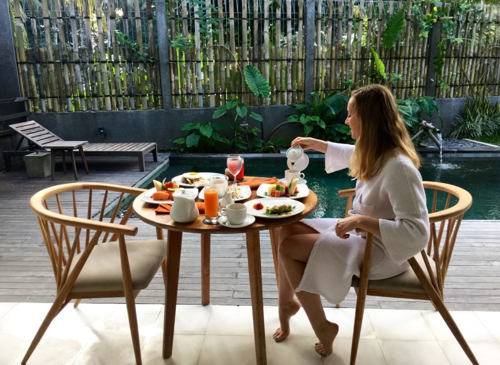 Maddy serving breakfast by the pool in Ubud