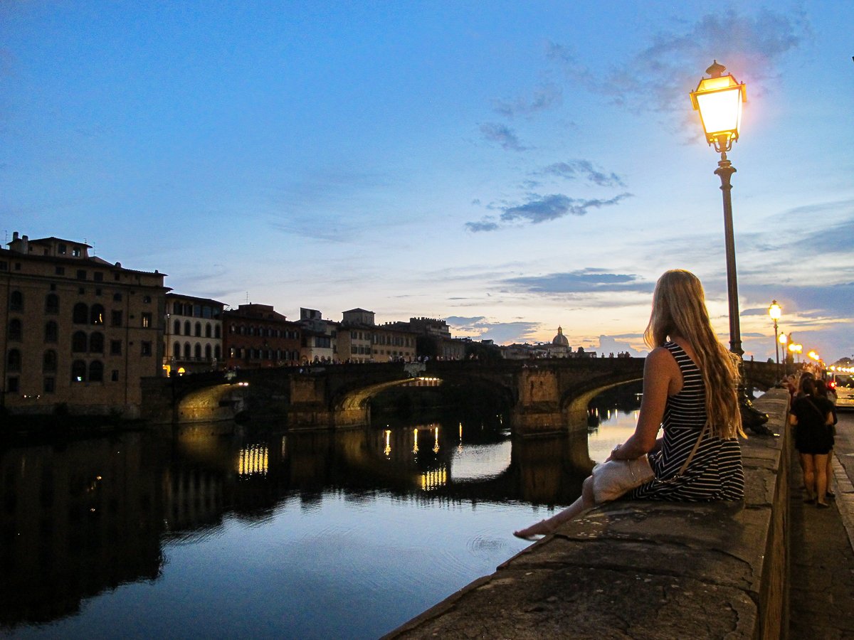 Maddy hanging out by a bridge along the Arno River at sunset - a good way to end the first day of 3 days in Florence