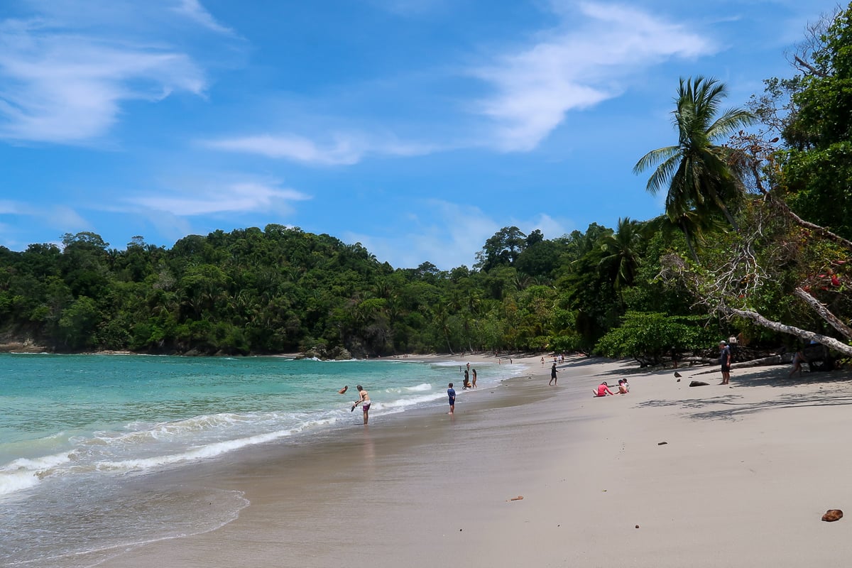 Groups of people relaxing on a beach in Manuel Antonio National Park