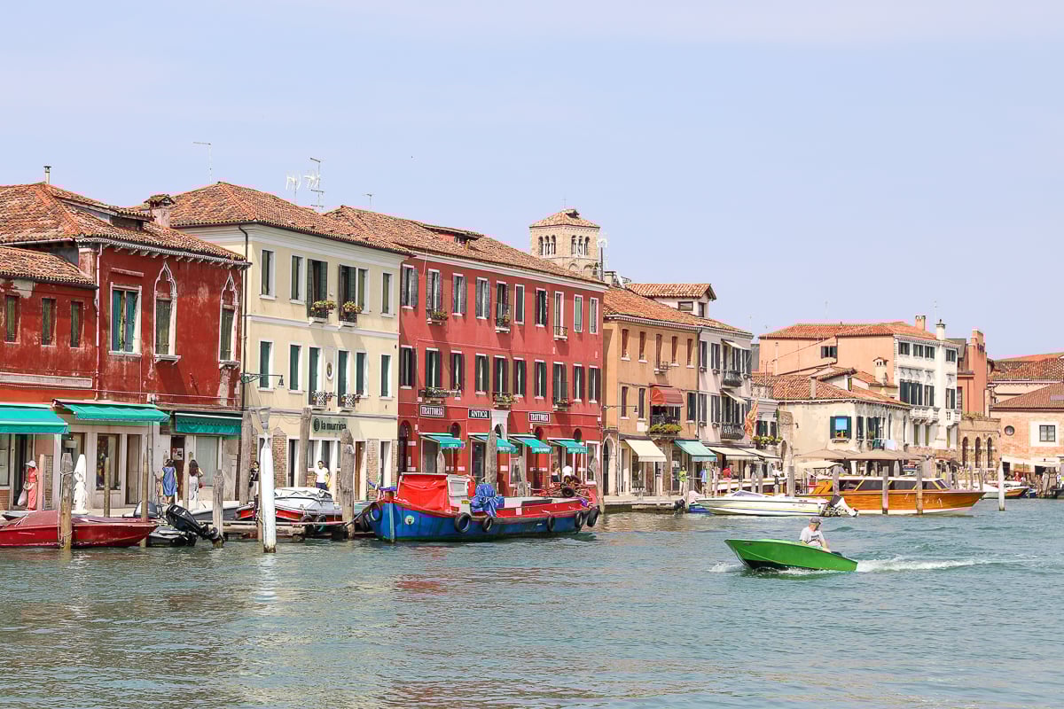 The colorful grand canal of Murano with a boat foating by