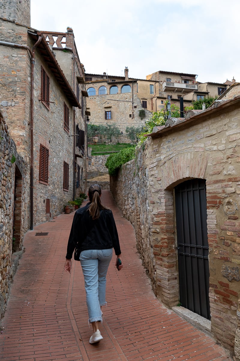 Maddy walking up the quiet streets of San Gimignano