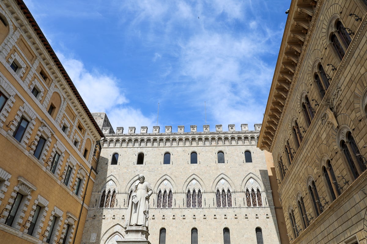 Statue of Sallustio Bandini standing in Piazza Salimbeni in Siena, a must-see during your Tuscany day trip