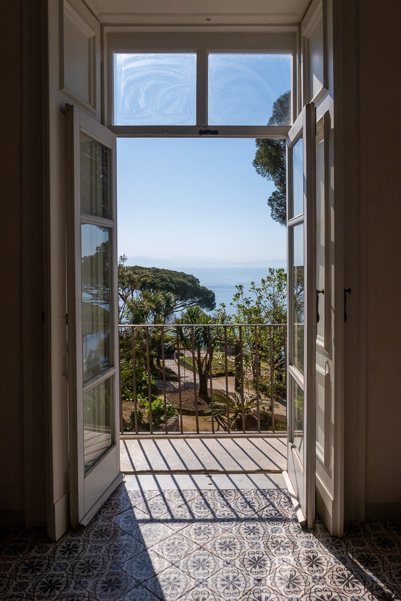 Hotel door leading to a terrace with a view of the gardens in Ravello