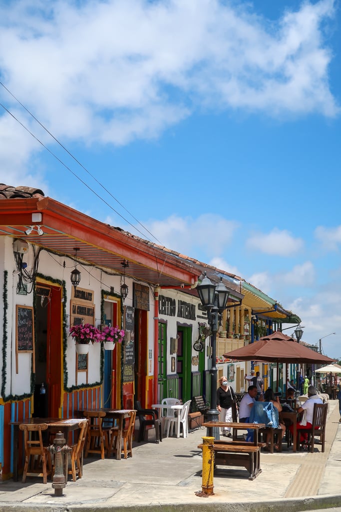 A group of people enjoying the food in an outdoor table in front of restaurants in Salento