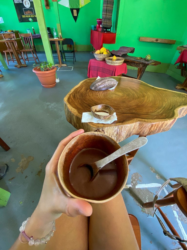 Melanie holding a hot chocolate - taking a chocolate workshop is one of the best things to do in San Ignacio, Belize!