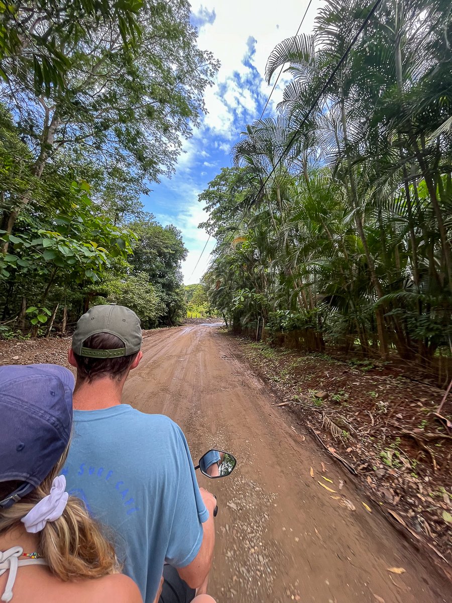 Maddy and Cacey riding a scooter along the dirt roads of Playa Avellanas